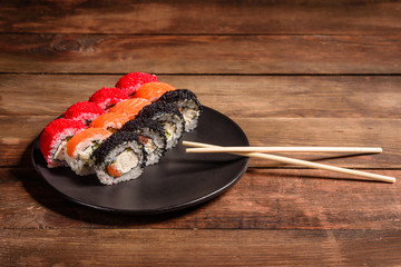 Various kinds of sushi served on a dark background