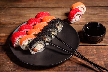 Various kinds of sushi served on a dark background