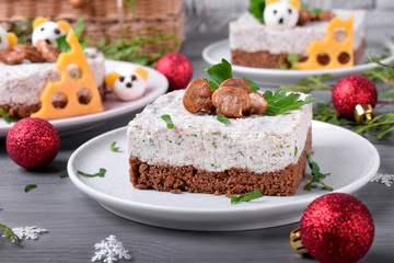 Salty cheesecake garnished with roasted champignons. New Year 2020 appetizer with the mouse of quail eggs, symbol of the new year