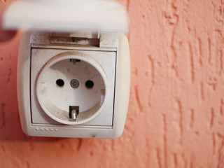 street socket. Against the background of corals. Great view. on the facade of the house. Industrial street socket, closed from moisture and dust