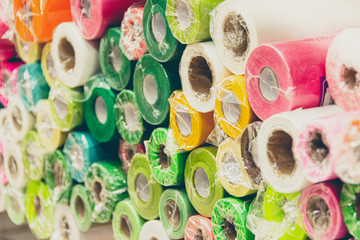 Rolls of colored wrapping paper on counter of store. Holiday and scrapbooking goods
