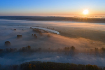 Sunny and foggy morning over the river, fog in the sun.