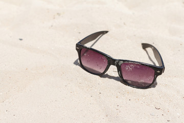 Sunglasses be stained with sand. Summer Vacation