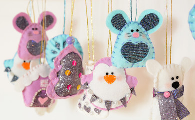 Various Christmas decorations hanging on ribbon