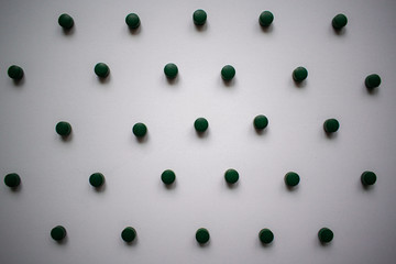 Green tablets on a white background.