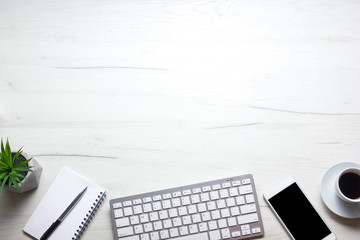 White desk office with laptop, smartphone and other work supplies with cup of coffee. Top view with...