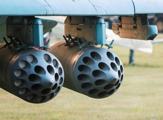 army military rocket launcher on the wing of an airplane