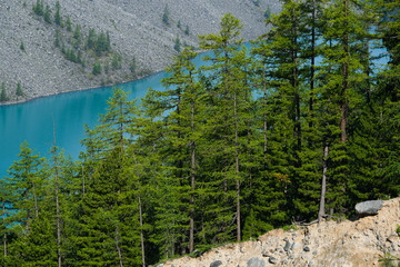 Turquoise lake among rocks. Mountain pond for hiking