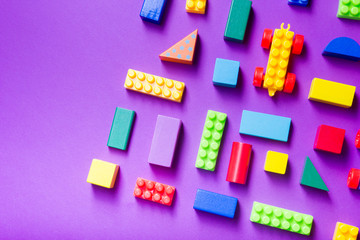 Colorful kids toys frame on wooden background. Top view. Flat lay. Copy space for text.