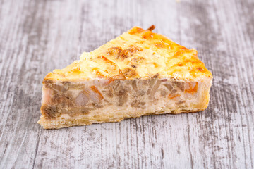 Piece of chopped dough pie with smoked chicken brisket inside