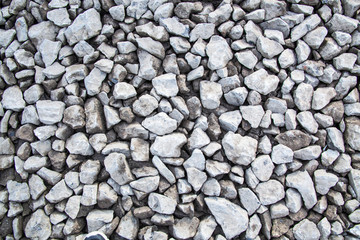 Ground granite stones as gray background.