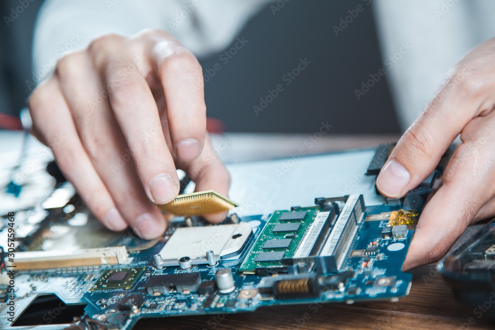 Poster the technician is putting the cpu on the socket of the computer motherboard