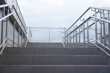 Steel handrails of a modern staircase on a city street