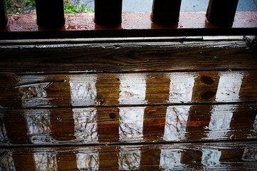 Wooden porch gets wet by rain