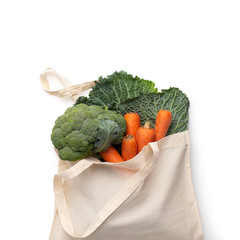 Reusable cotton bag with fresh bio vegetables isolated on white