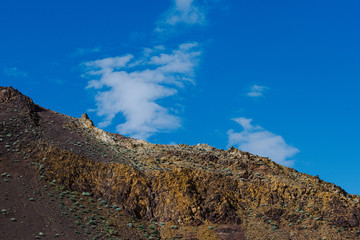 Rocks under blue sky. Sunny day in mountain valley. Colorful hills, Hiking in summer