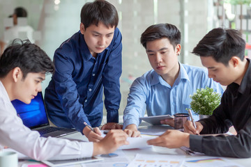 Group of young asian business people working and brainstorming and exchanging ideas at the meeting. © amnaj