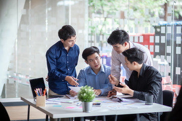 Group of young asian business people working and brainstorming and exchanging ideas at the meeting.