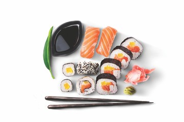A sushi set. 10 pieces with salmon and yellow pickled radish - nigiri, maki, wasabi, ginger, soy sauce and chopsticks. A packshot photo, isolated on white.