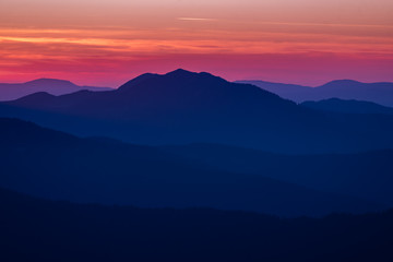 Obraz na płótnie Canvas Colorful sunset over the mountain hills
