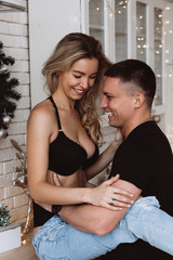 Romantic christmas evening of a young couple. New year love story. Photo session of lovers in the...