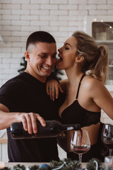A guy with a girl is celebrating Christmas. A loving couple enjoys each other on New Year's Eve in a cozy home environment. New Year's love story.