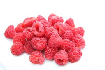 Closeup ripe sweet raspberries on white background. Selective focus.