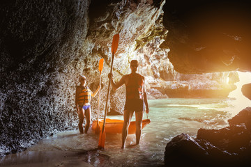 Couple of kayakers in sea cave