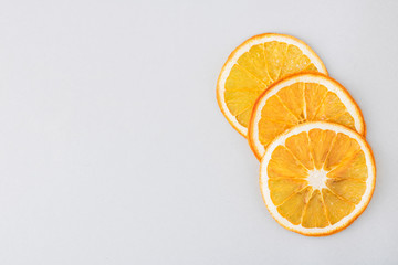 Eco organic homemade dried orange slices, chips. Dehydrated crispy fruit slices. Heap, pile of sun dried crunchy oranges. Healthy snack. Close up. Top view. Copy space