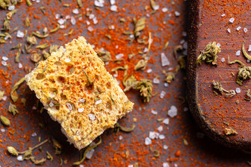 Crouton with salt and spices over wood table