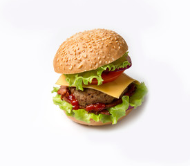Homemade hamburger on white background. Hamburger with sesame seeds and bacon, greens and cheese.