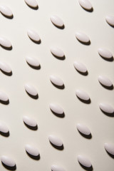 White pills linen pattern on white background. Healthcare and medical concept.