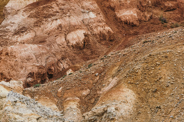 Red hills in canyon. Red colored rocks. Old bed of river in gorge