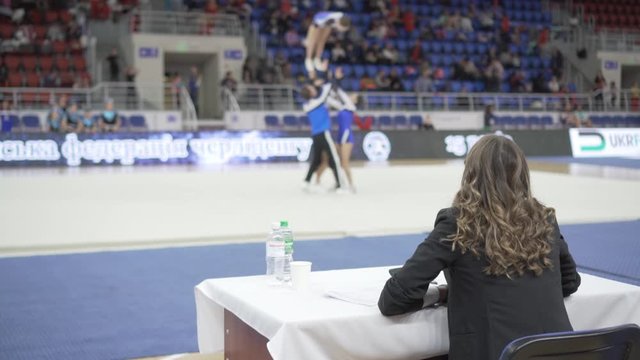 Woman judge at the competition, evaluates the performance of athletes