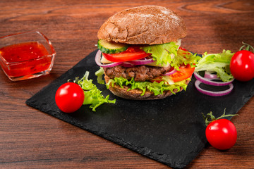 Tasty rye hamburger with tomatoes