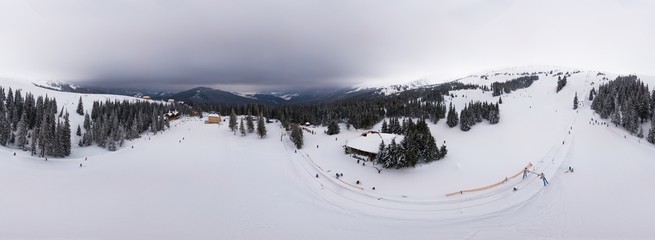 Aerial ski 360 panorama of gentle hills and mountain