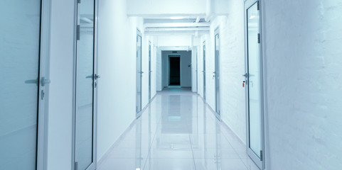 Empty corridor in hospital with closed doors