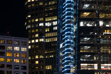 Fototapeta na wymiar Modern urban scene of glowing lights and glass windows of skyscrapers at night