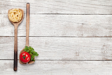 Pasta and ingredients in spoons