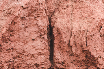 Red mountainside on hot day. Texture on wall of sandy canyon. Lack of water, drought from climate change