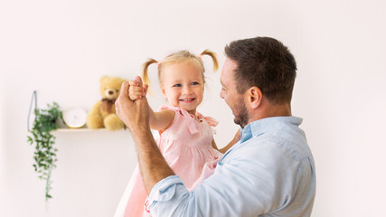 Portrait of daughter dancing with her dad