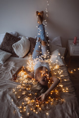 New Year photo session of a young girl. Sexy blonde.Cozy atmosphere in the studio.