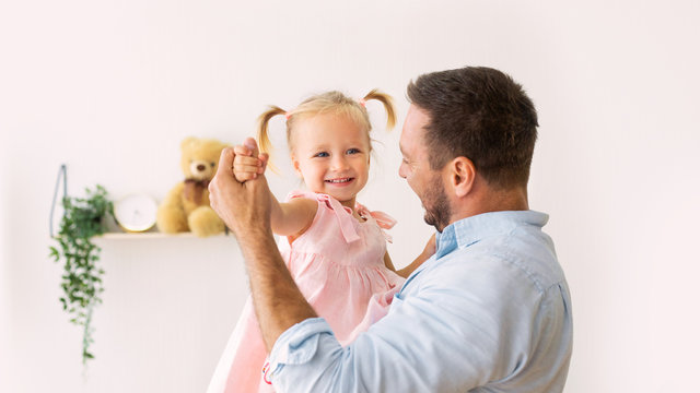 Portrait Of Daughter Dancing With Her Dad