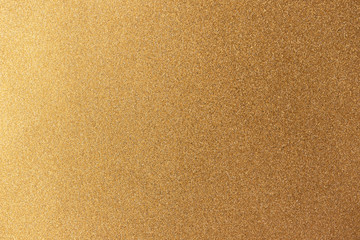Fototapeta na wymiar Golden glitter shiny background. New Year or Christmas wrapping holiday paper texture, horizontal format