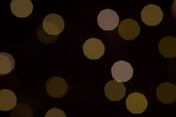 Yellow glitter boke background texture on black