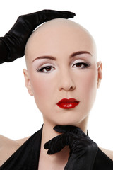 Portrait of beautiful skinhead woman with red lips and false eyelashes