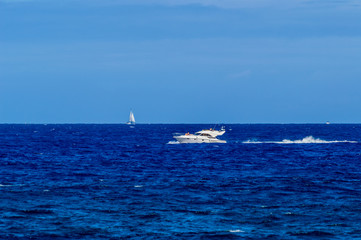 Fototapeta premium Outboard Enjoying A Recreational Day In The Bay On Las Americas Beach. April 11, 2019. Santa Cruz De Tenerife Spain Africa. Travel Tourism Street Photography.