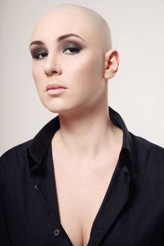 Portrait of skinhead woman with smoky eye makeup