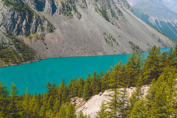 Turquoise lake among rocks. Mountain pond for hiking