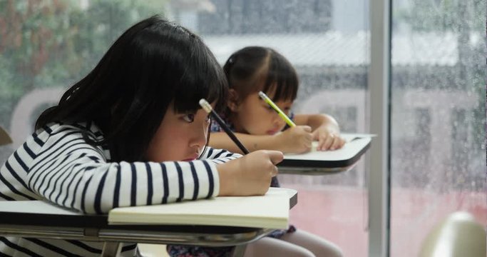 Asian children not interested studying lazy and sleepy in the classroom at school. Concept of education.